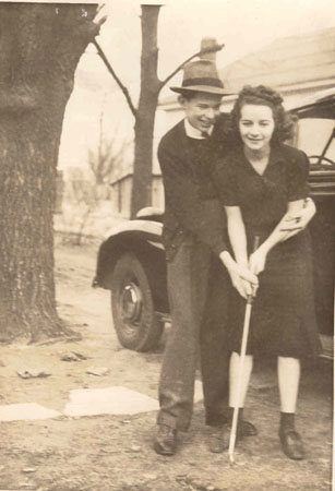 couple learning to play golf
