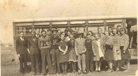 large group in front of bus